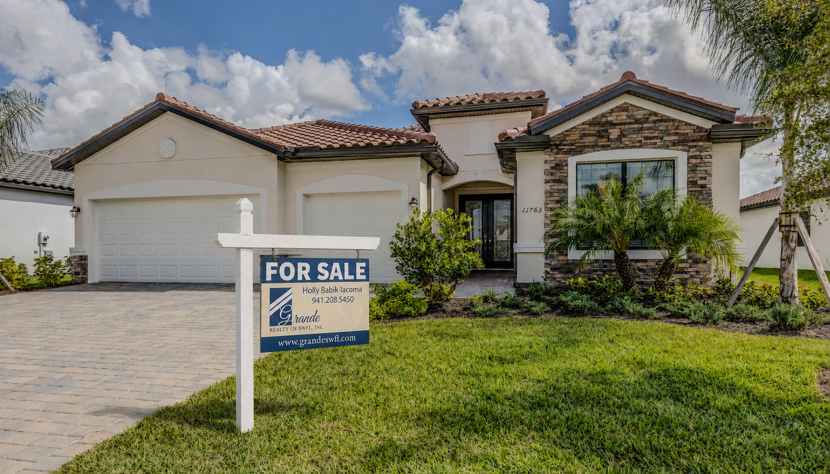 Grande Realty residential for-sale sign shown outside a Southwest Florida home